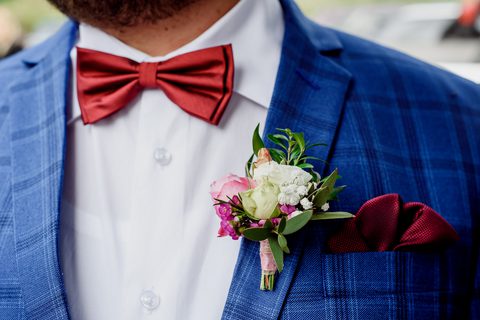 Groom with blue suit and red bow tie